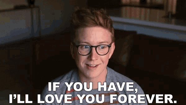 a young man wearing glasses is sitting on a couch and saying if you have i 'll love you forever .
