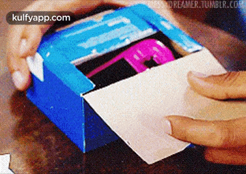 a person is opening a blue box with the words kulfyapp.com in the corner