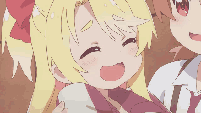 a girl with blonde hair and a red bow on her head