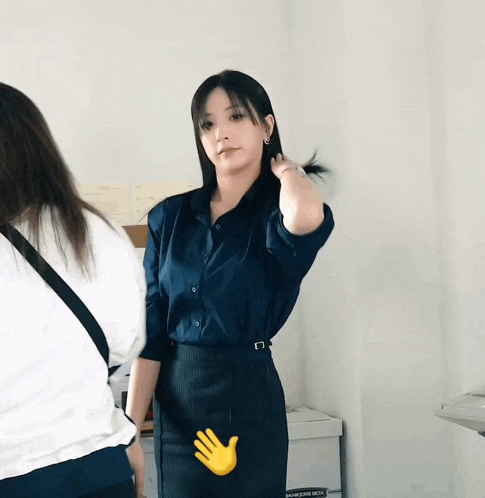 a woman in a blue shirt is standing next to a box that says ' manpower hire ' on it