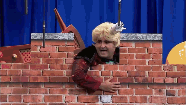 a man in a wig is peeking through a brick wall