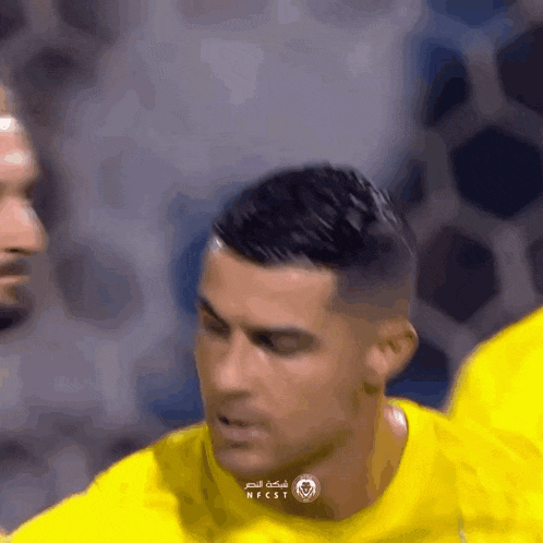 a man in a yellow shirt with nfcst written on his shirt