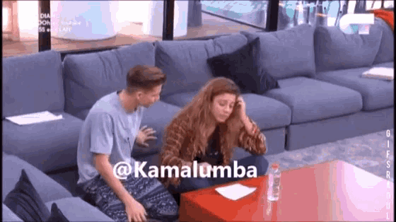a man and a woman are sitting on a couch with the hashtag kamalumba on the table