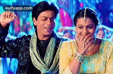 a man and a woman are standing next to each other laughing .