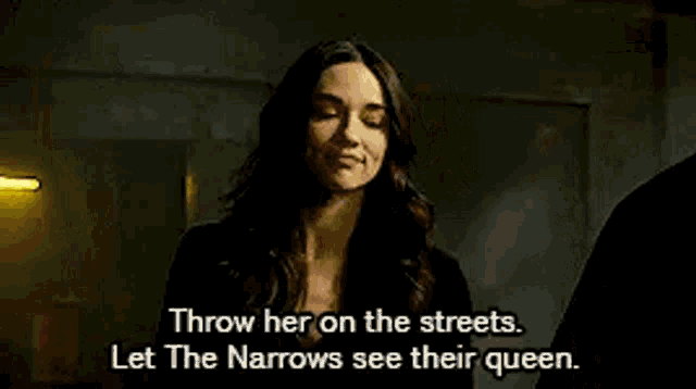 a woman is standing in a dark room with a yellow light behind her and a quote .