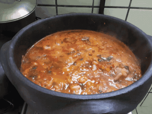 a pot of stew is cooking on the stove