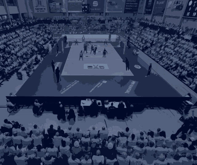 a basketball game is being played in a stadium with a few people watching