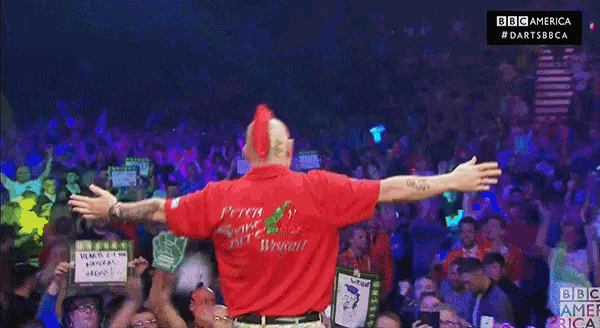 a man wearing a red shirt that says budweiser on the front