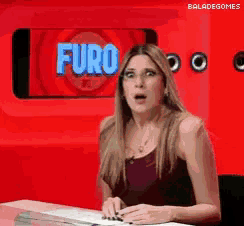 a woman in front of a screen that says furo on it