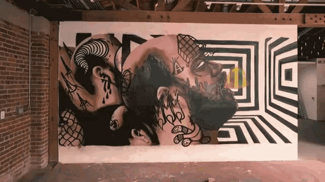 a wall with a painting of a man with a beard and tattoos