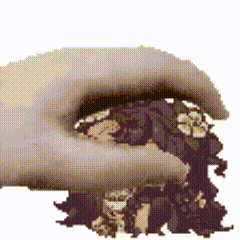 a pixelated image of a hand holding a pile of nuts