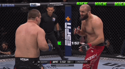 two men are fighting in a boxing ring with 1:52 left in the fight