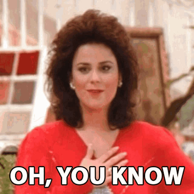 a woman in a red dress is holding her hands to her chest and says oh you know