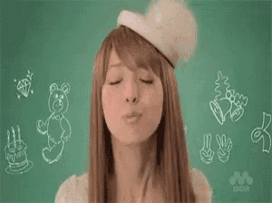 a woman is smiling with a heart in her mouth