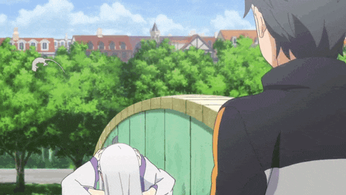 a man and a woman are standing next to each other in a park with trees in the background