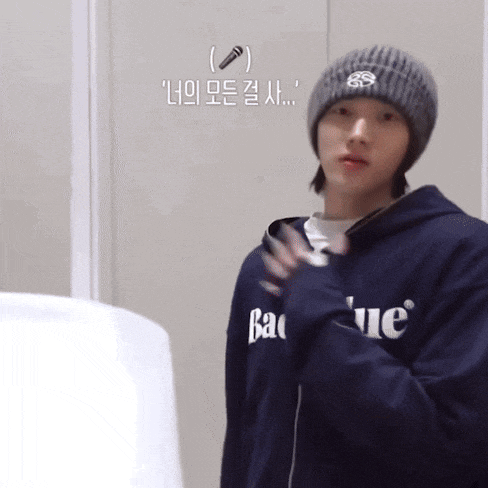 a man wearing a beanie and a hoodie that says ' bao ' on it