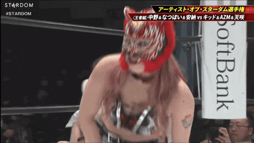 a woman in a wrestling ring with a sign that says softbank