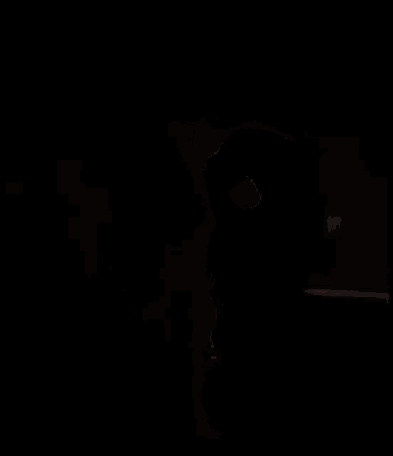 a close up of a person 's face in the dark with a light coming out of a window .