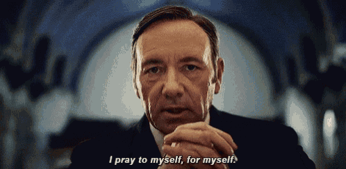 a man in a suit and tie is praying to himself for myself .