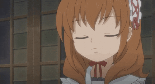 a girl with brown hair and a red bow on her neck smiles with her eyes closed
