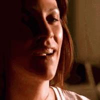a close up of a woman 's face smiling with her mouth open .