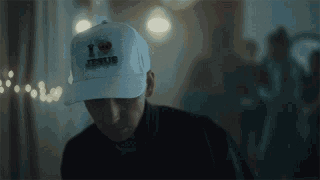 a man wearing a hat that says i love jesus on it