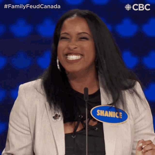 a woman with a name tag that says shanice is smiling