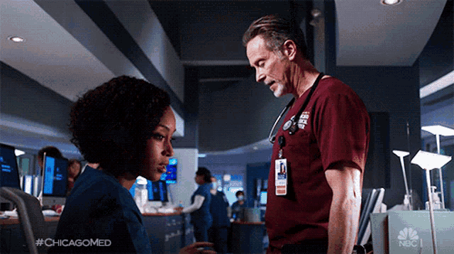 a man and a woman are standing next to each other in a hallway with the hashtag #chicagomed