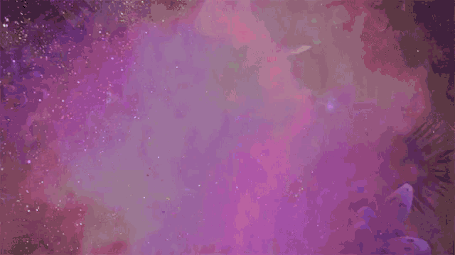 a group of people are dancing in a dark room surrounded by purple smoke .