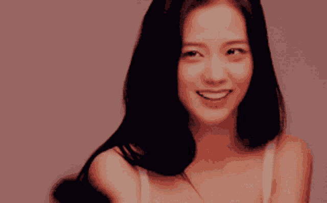 a woman in a white bra is smiling and looking at the camera