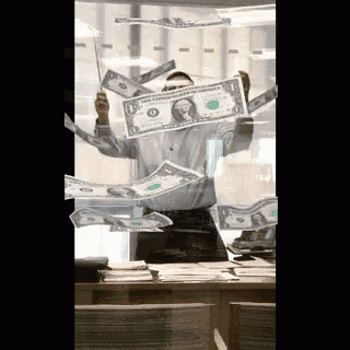 a man is holding a dollar bill in his hand while money is falling around him
