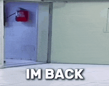 a fire extinguisher is hanging on a wall next to a door that says im back
