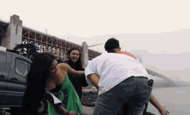a woman in a green dress is being held by a man