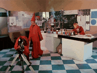 a man in a red robe is looking through a telescope in a room