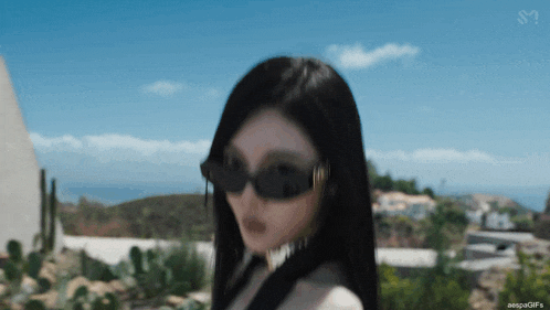 a blurry picture of a woman wearing sunglasses with the caption aespa gifs