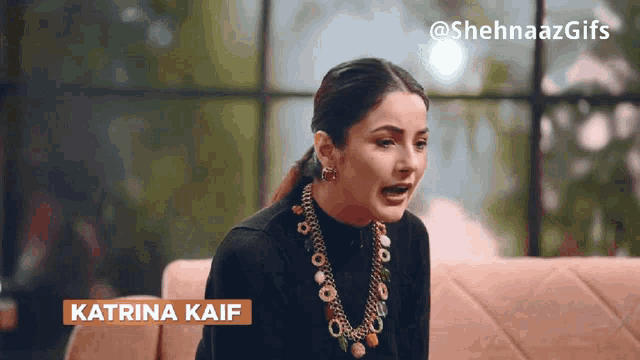a woman sitting on a couch with the name katrina kaif on the bottom right