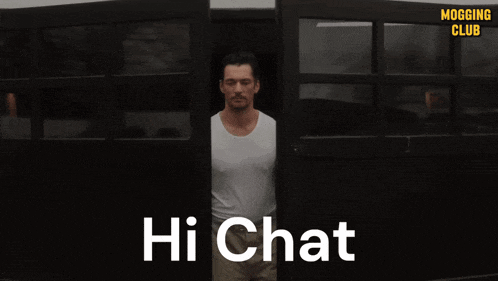 a man with his arms outstretched is standing in front of a sign that says hi chat