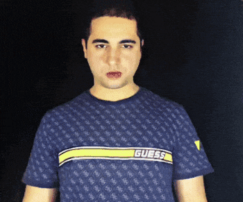 a man wearing a blue shirt with the word guess on the front