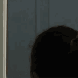 a close up of a person standing in a doorway .