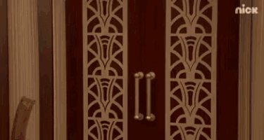 a man in a superhero costume is standing in a doorway and says hai .