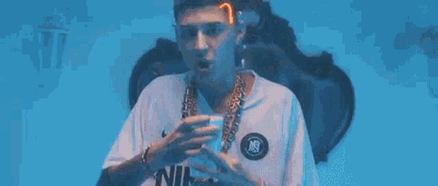 a young man is smoking a cigarette in a dark room .