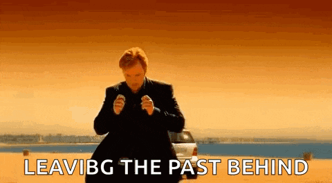 a man in a suit is standing in front of a car with the words `` leaving the past behind '' .