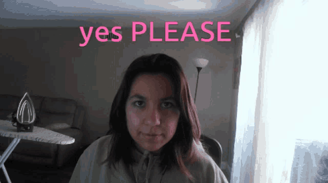 a woman is sitting in front of a sign that says " yes please "