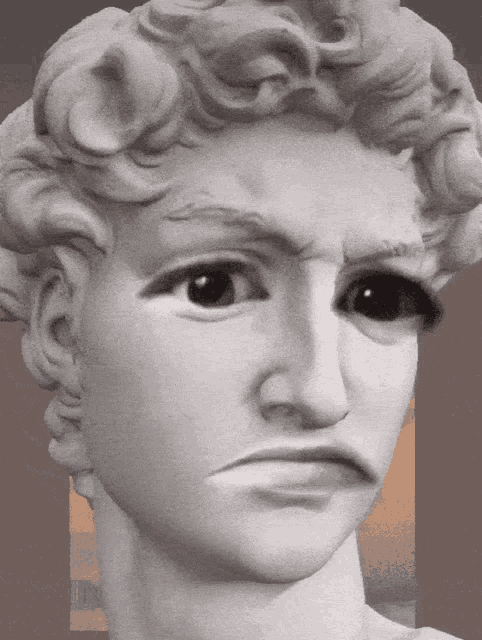 a close up of a statue of a man with a serious look on his face