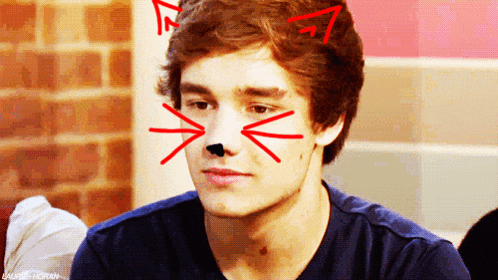 a young man has a cat nose drawn on his face