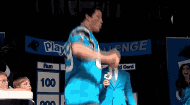 a man in a blue shirt with the number 3 on it