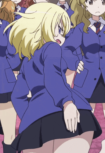 a girl in a blue jacket is standing in front of a group of girls