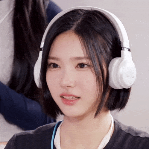 a woman wearing a pair of white headphones that say jbl