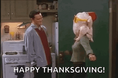 a man and a woman are standing in a kitchen with a turkey on their shoulders .