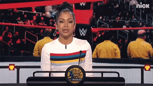 a woman is standing behind a podium that says double dare